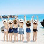 Travelers wearing swimwear on a sunny beach in Quy Nhon, Vietnam