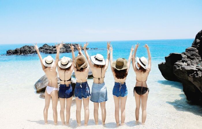 Travelers wearing swimwear on a sunny beach in Quy Nhon, Vietnam