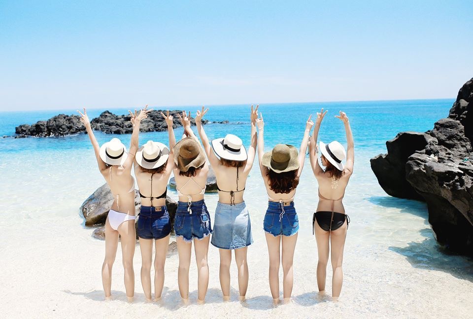Travelers wearing swimwear on a sunny beach in Quy Nhon, Vietnam