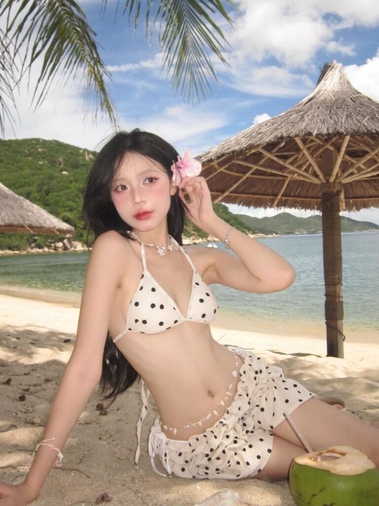 Traveler wearing a polka-dot bikini and matching beach cover-up in Quy Nhon